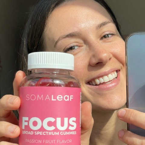 Customer holding SomaLeaf FOCUS gummies