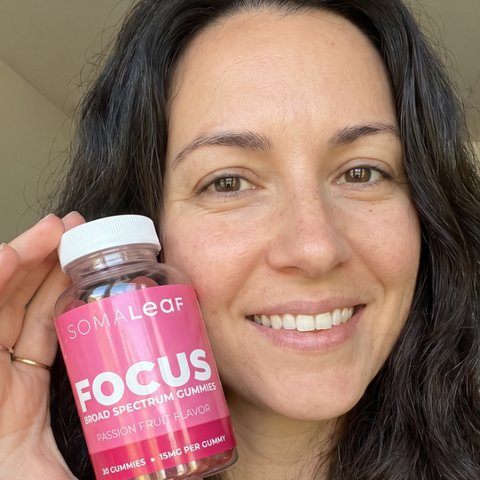 Lisa holding SomaLeaf FOCUS gummies